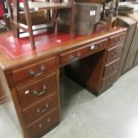 A good quality oak desk with leather inset top.