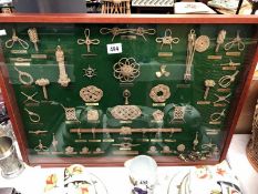 A boxed display of knots (with glass top) some pieces loose