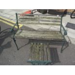 A garden bench with cast iron ends & a stool