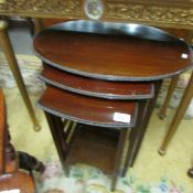 A nest of 3 mahogany tables.