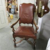 A wood and leather arm chair.