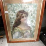 A Victorian portrait of a lady in a birds eye maple frame.