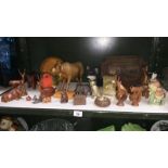 A shelf of wooden animals etc.