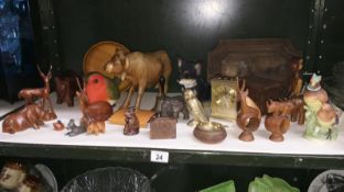 A shelf of wooden animals etc.