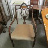 An Edwardian mahogany inlaid elbow chair.