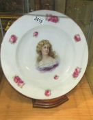 A large cabinet plate with portrait of a lady.