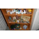 3 shelves of miscellaneous including money boxes, candles etc.