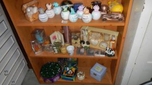3 shelves of miscellaneous including money boxes, candles etc.