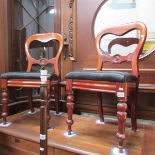 A pair of mahogany dining chairs.