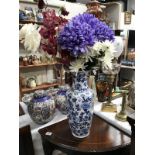 A blue & white flower pattern vase with faux flowers