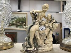 A glazed alabaster figure consisting of 3 cherubs & a horned goat