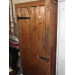 A wooden storage cabinet with solid pine door