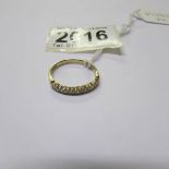 An 18ct yellow gold and diamond half eternity ring, size R.