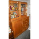 A beech bookcase with glazed top and cupboard/drawer base