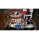 A box of miscellaneous including a cased cutlery set, digital clock,