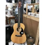 A Hondo 2 acoustic guitar with carrying case (stand not included)