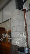 A wrought iron clothes stand