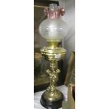 A good quality oil lamp with figural column and etched shade.