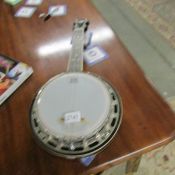 A banjo with mother of pearl inlay by Vintage.