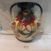 A large twin handled Moorcroft Anna Lily vase, approximate height 10.