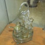 A silver plate cruet set with glass bottles.