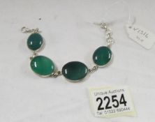 A green stone bracelet set in silver.