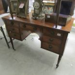 A mahogany kneehole desk.