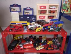 2 shelves of assorted model vehicles including 3 Corgi Queen Mother Centenary trams (1 boxed)