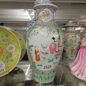 A large oriental vase hand painted with a garden scene.