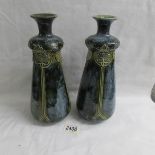 A pair of early Doulton vases bearing the marks gs and mh.