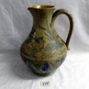 A Doulton Lambeth jug featuring hounds chasing stag by Hannah Barlow.