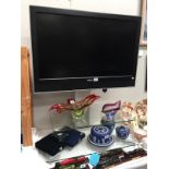 A Toshiba 37" flat screen TV fixed to glass stand