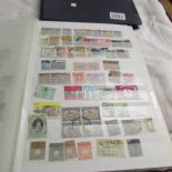 2 stock books of world stamps including Belgian Congo, Australia, Spain, Sarawak, Uganda, Kenya,