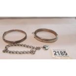 2 silver bangles and a silver wrist chain with lock.