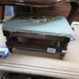 A footstool with tapestry top.