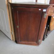 An oak corner cupboard.