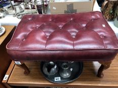 A red leather footstool