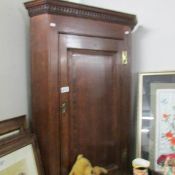 An oak corner cupboard.
