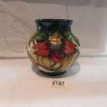 A Moorcroft Anna Lilly pattern jardiniere vase, approximately 5.75" tall.