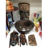 1 large and 3 small wooden masks and graduated set of 3 wooden bowls