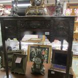 A carved oak lowboy.