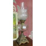 A Victorian oil lamp on metal base with glass font and later glass shade.