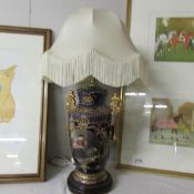 A pottery table lamp with shade.