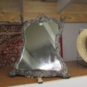 A large silver framed mirror (would benefit from a clean).