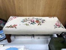 An embroidered topped footstool