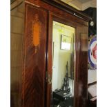 A mahogany inlaid wardrobe.