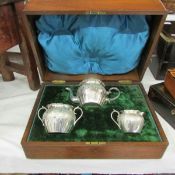 A late 19th century cased 3 piece silver plate Bachelor's tea set with markings believed to be