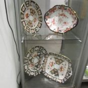 4 Royal Crown Derby plates in various designs and sizes.