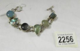 A mixed gem set bracelet in silver.