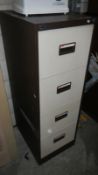 A metal 4 drawer filing cabinet